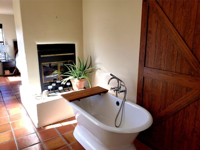 2730 La Silla Dorada, Santa Fe, NM 87505 - bathroom with a freestanding bath, tile patterned flooring, and a glass covered fireplace
