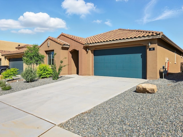 13 Firecrown Ln, Santa Fe, NM 87508 - mediterranean / spanish-style home with stucco siding, an attached garage, driveway, and a tiled roof