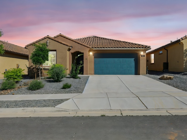 13 Firecrown Ln, Santa Fe, NM 87508 - mediterranean / spanish-style house with a garage, stucco siding, driveway, and a tile roof