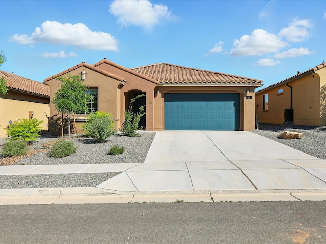 13 Firecrown Ln, Santa Fe, NM 87508 - mediterranean / spanish house with an attached garage, stucco siding, driveway, and a tile roof