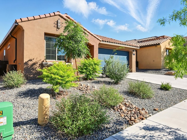 13 Firecrown Ln, Santa Fe, NM 87508 - mediterranean / spanish home featuring concrete driveway, an attached garage, a tiled roof, and stucco siding