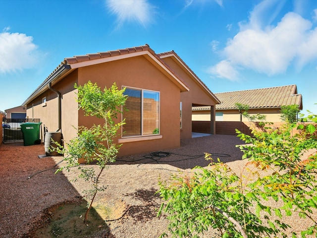 13 Firecrown Ln, Santa Fe, NM 87508 - view of property exterior featuring stucco siding, a tile roof, and a patio area