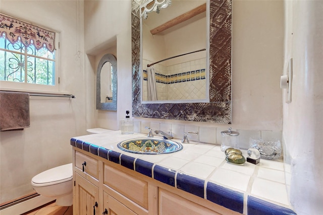 952 Acequia Madre, Santa Fe, NM 87505 - bathroom featuring a baseboard radiator, vanity, and curtained shower