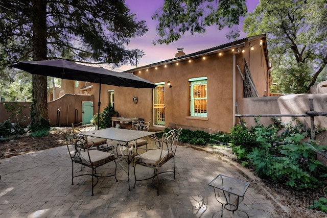 952 Acequia Madre, Santa Fe, NM 87505 - patio terrace at dusk with outdoor dining space and a patio area