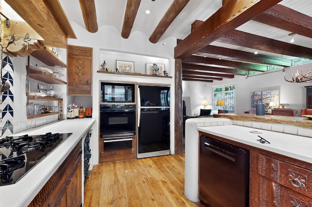 952 Acequia Madre, Santa Fe, NM 87505 - kitchen featuring black appliances, light wood-style flooring, a warming drawer, beamed ceiling, and light countertops