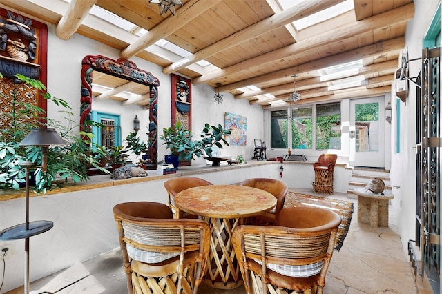 952 Acequia Madre, Santa Fe, NM 87505 - dining room featuring a wood ceiling with exposed beams, stone finish floors, and a skylight