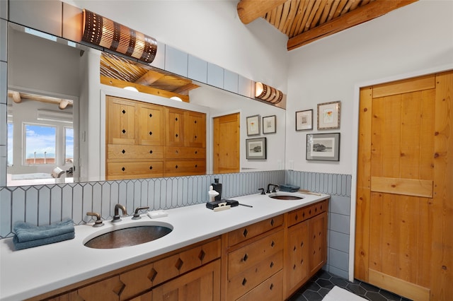 15 Cielo Cumbre Rd, Santa Fe, NM 87505 - bathroom featuring double vanity, beamed ceiling, tile patterned floors, and wainscoting
