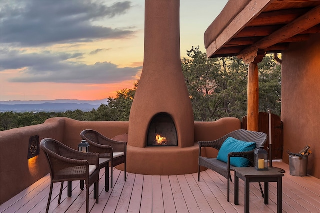 15 Cielo Cumbre Rd, Santa Fe, NM 87505 - deck at dusk with a lit fireplace