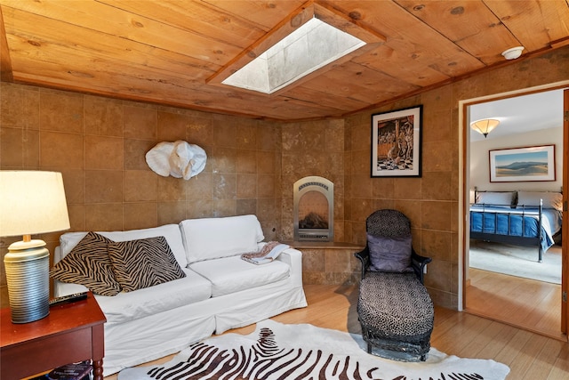 15 Cielo Cumbre Rd, Santa Fe, NM 87505 - living area featuring a skylight, wood-type flooring, wooden ceiling, tile walls, and heating unit