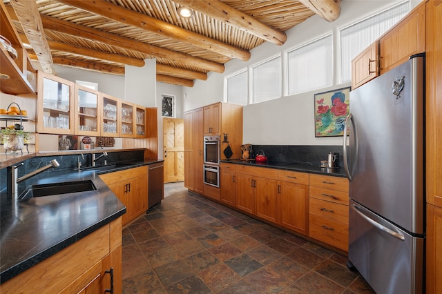 15 Cielo Cumbre Rd, Santa Fe, NM 87505 - kitchen featuring appliances with stainless steel finishes, dark countertops, stone tile flooring, a wood ceiling with exposed beams, and glass insert cabinets