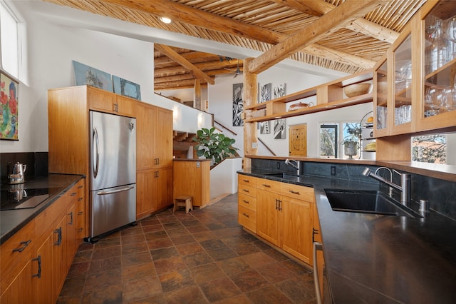 15 Cielo Cumbre Rd, Santa Fe, NM 87505 - kitchen featuring freestanding refrigerator, black electric cooktop, dark stone finish floors, open shelves, and beamed ceiling