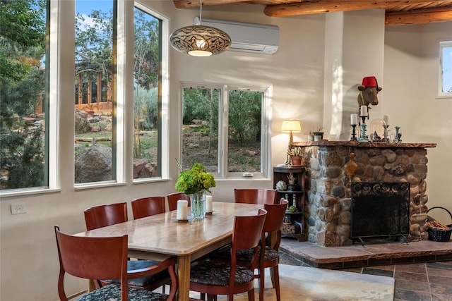 15 Cielo Cumbre Rd, Santa Fe, NM 87505 - dining area with a wall mounted AC, beamed ceiling, and a fireplace