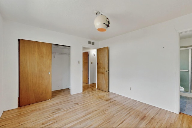 1017 Practilliano Dr, Santa Fe, NM 87505 - unfurnished bedroom with light wood-style floors, a closet, and ensuite bath