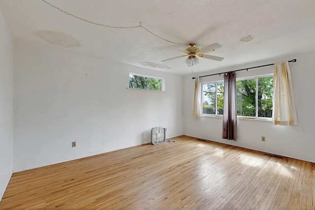 1017 Practilliano Dr, Santa Fe, NM 87505 - empty room featuring plenty of natural light, light wood finished floors, and a ceiling fan
