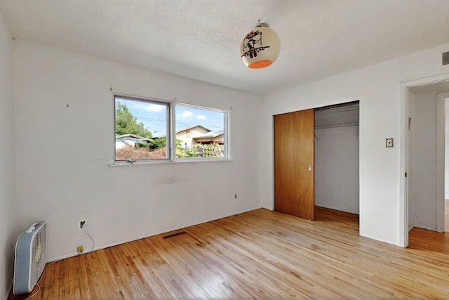 1017 Practilliano Dr, Santa Fe, NM 87505 - unfurnished bedroom with light wood-style flooring and a closet