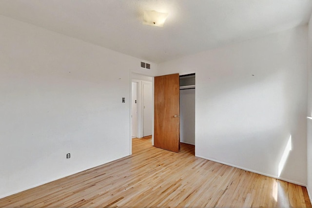 1017 Practilliano Dr, Santa Fe, NM 87505 - unfurnished bedroom featuring light wood-type flooring and a closet