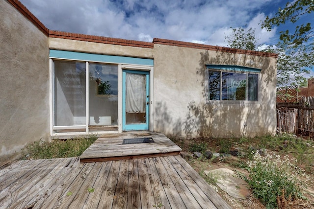 1017 Practilliano Dr, Santa Fe, NM 87505 - view of exterior entry with a deck and stucco siding