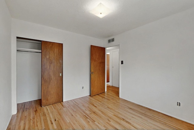 1017 Practilliano Dr, Santa Fe, NM 87505 - unfurnished bedroom with light wood finished floors and a closet