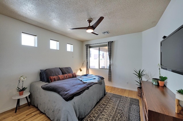139 Rancho Viejo Blvd, Santa Fe, NM 87508 - bedroom featuring light wood-style floors, a textured ceiling, and a ceiling fan