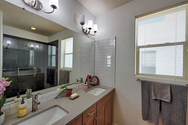 139 Rancho Viejo Blvd, Santa Fe, NM 87508 - full bathroom with double vanity, healthy amount of natural light, tiled shower, and a textured ceiling
