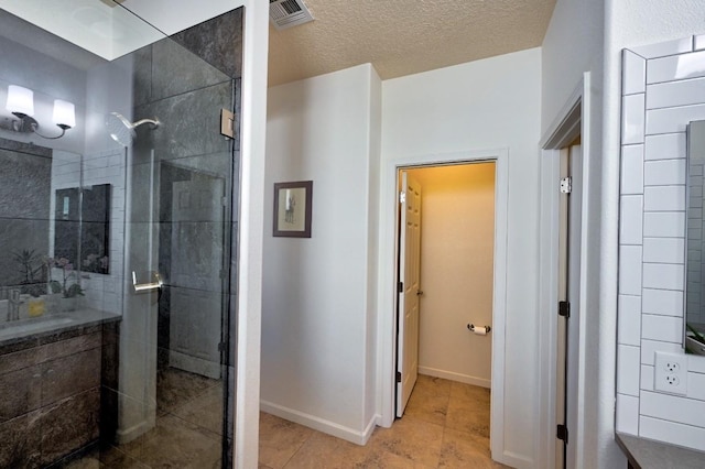 139 Rancho Viejo Blvd, Santa Fe, NM 87508 - bathroom featuring a stall shower, tile patterned floors, and a textured ceiling