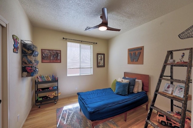 139 Rancho Viejo Blvd, Santa Fe, NM 87508 - bedroom with wood finished floors, a textured ceiling, and ceiling fan