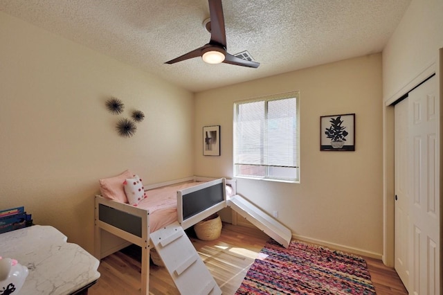 139 Rancho Viejo Blvd, Santa Fe, NM 87508 - bedroom featuring a textured ceiling, a closet, wood finished floors, and ceiling fan