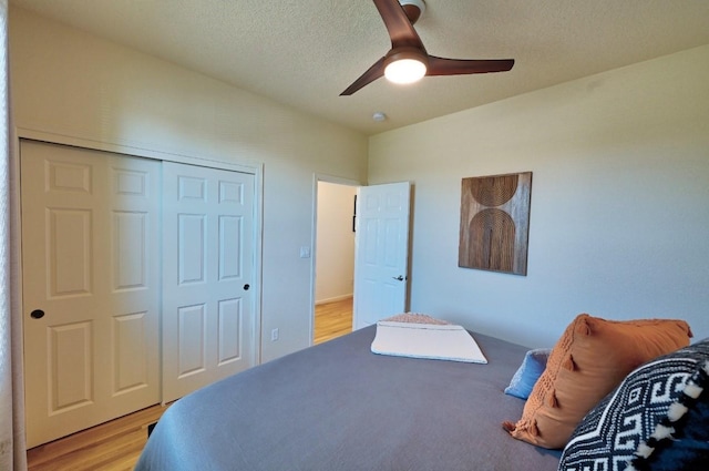 139 Rancho Viejo Blvd, Santa Fe, NM 87508 - bedroom with a closet, light wood finished floors, a textured ceiling, and a ceiling fan