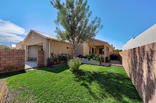 139 Rancho Viejo Blvd, Santa Fe, NM 87508 - rear view of property with stucco siding, a fenced backyard, an attached garage, and a metal roof