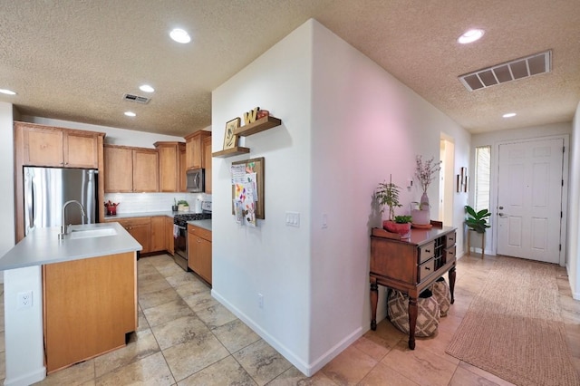 139 Rancho Viejo Blvd, Santa Fe, NM 87508 - kitchen featuring stainless steel appliances, a textured ceiling, recessed lighting, backsplash, and an island with sink