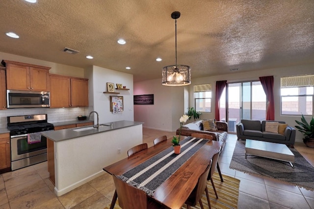 139 Rancho Viejo Blvd, Santa Fe, NM 87508 - dining space with a textured ceiling, plenty of natural light, recessed lighting, a chandelier, and light tile patterned flooring