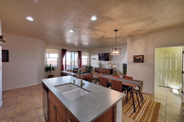 139 Rancho Viejo Blvd, Santa Fe, NM 87508 - kitchen featuring dishwasher, a textured ceiling, light tile patterned flooring, decorative light fixtures, and open floor plan
