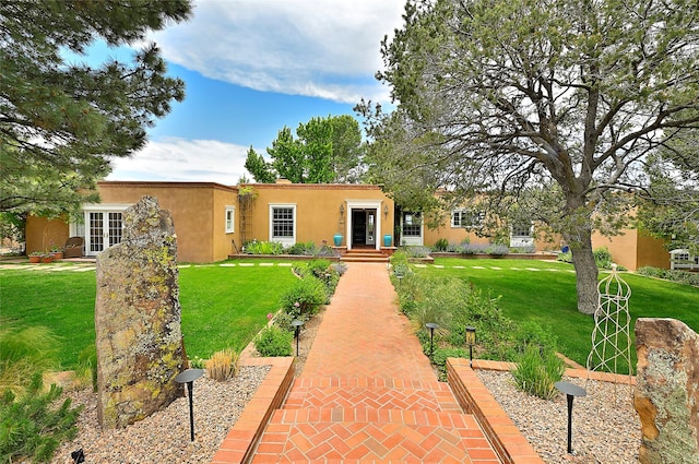 1110 Old Santa Fe Trl, Santa Fe, NM 87505 - view of front of house featuring stucco siding, a front lawn, and french doors