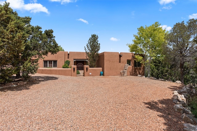 1203 Sierra Del Este, Santa Fe, NM 87501 - back of property with a gate and stucco siding