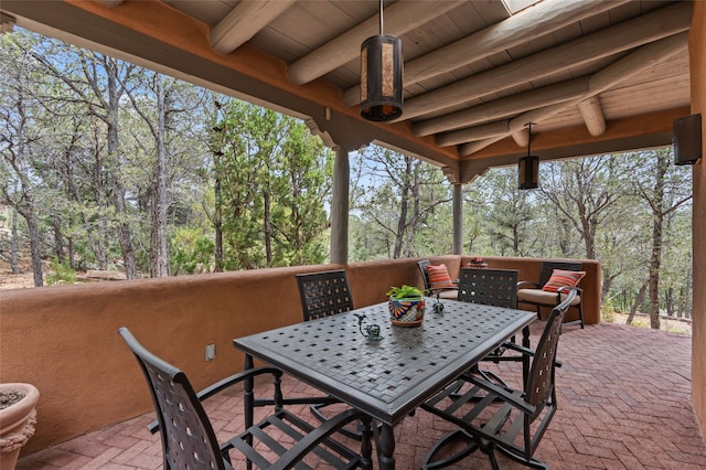 1203 Sierra Del Este, Santa Fe, NM 87501 - view of patio with outdoor dining area and view of wooded area