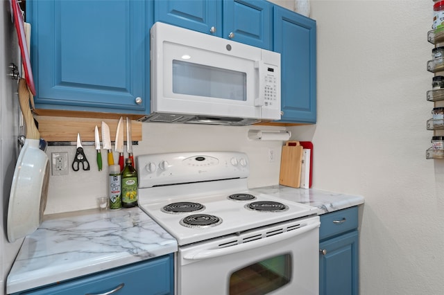 7206 Avenida El Nido, Santa Fe, NM 87507 - kitchen with white appliances and blue cabinetry