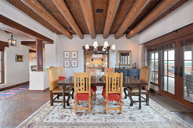 95 Lodge Trl, Santa Fe, NM 87506 - dining space with french doors, a chandelier, brick flooring, and a wood ceiling with exposed beams