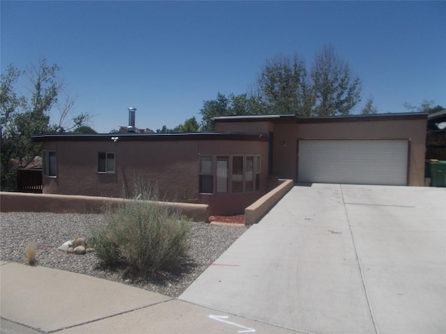 3408 Northridge Ct, Farmington, NM 87401 - view of front of house with an attached garage, concrete driveway, and stucco siding
