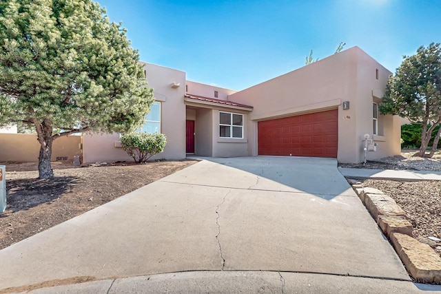 5 Wood Flower, Santa Fe, NM 87508 - adobe home with stucco siding, driveway, and a garage