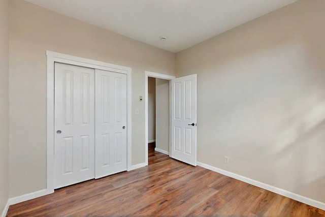 5 Wood Flower, Santa Fe, NM 87508 - unfurnished bedroom featuring wood finished floors and a closet