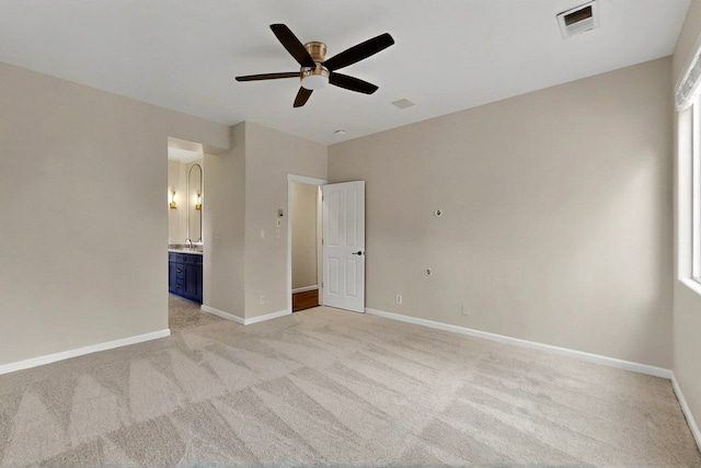 5 Wood Flower, Santa Fe, NM 87508 - unfurnished bedroom featuring light carpet, ensuite bath, and a ceiling fan