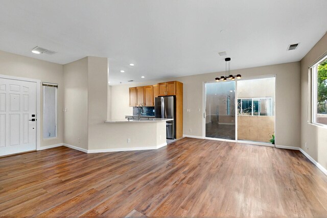5 Wood Flower, Santa Fe, NM 87508 - unfurnished living room featuring light wood-style floors and recessed lighting