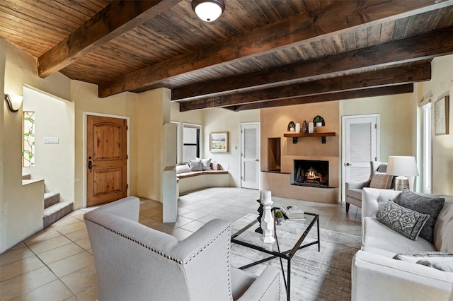 3046 Plaza Blanca, Santa Fe, NM 87507 - living area with a wood ceiling with exposed beams, light tile patterned floors, a lit fireplace, and stairway