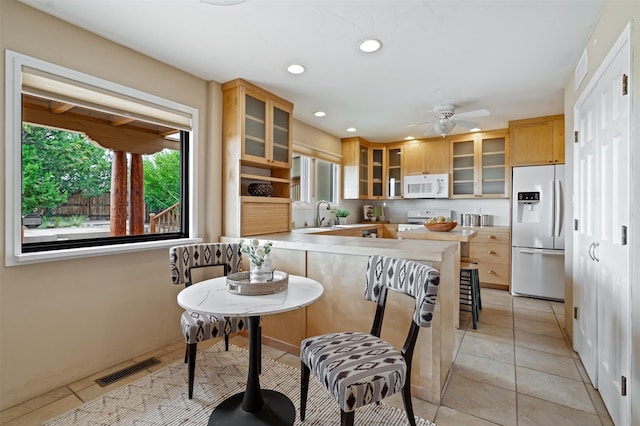 3046 Plaza Blanca, Santa Fe, NM 87507 - kitchen featuring white appliances, a peninsula, recessed lighting, glass insert cabinets, and ceiling fan