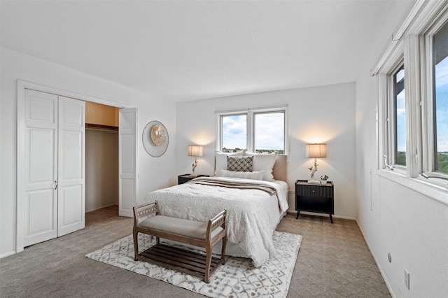 3046 Plaza Blanca, Santa Fe, NM 87507 - bedroom featuring multiple windows, light carpet, and a closet