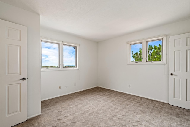 3046 Plaza Blanca, Santa Fe, NM 87507 - unfurnished bedroom featuring light carpet and baseboards