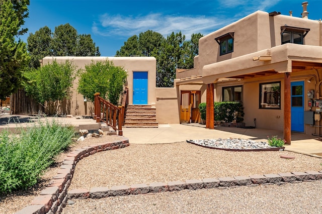 3046 Plaza Blanca, Santa Fe, NM 87507 - adobe home featuring stucco siding, a patio area, and a balcony