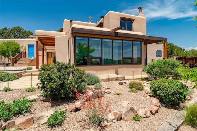 3046 Plaza Blanca, Santa Fe, NM 87507 - back of house with stucco siding and a chimney