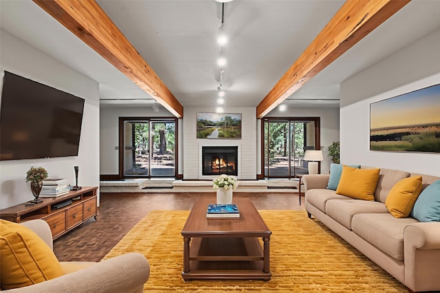 320 Valle Del Sol, White Rock, NM 87547 - living area with beam ceiling, rail lighting, plenty of natural light, a brick fireplace, and wood finished floors