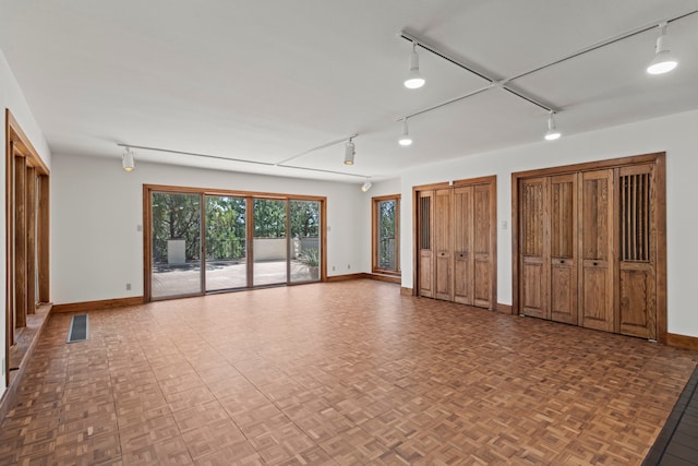 320 Valle Del Sol, White Rock, NM 87547 - unfurnished bedroom featuring track lighting, access to exterior, and two closets